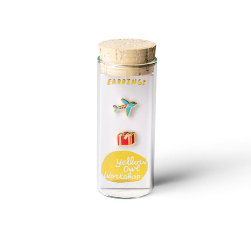 Airplane and suitcase mismatched cloisonné stud earrings in glass vial packaging by Yellow Owl Workshop