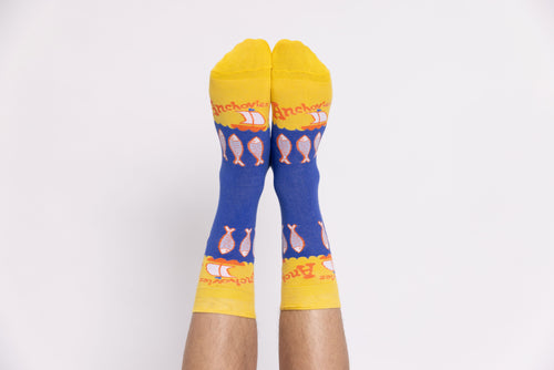 Blue and yellow Anchovies crew socks with illustrated fish worn on feet by Yellow Owl Workshop