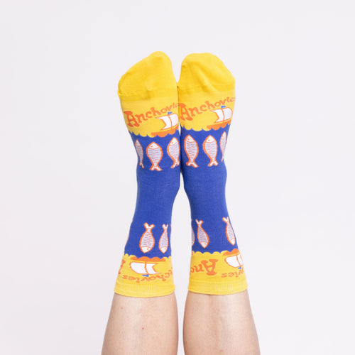 Blue and yellow Anchovies crew socks with illustrated fish worn on feet by Yellow Owl Workshop