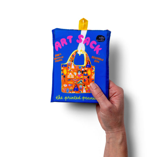 Person holding orange illustrated art history tote bag with folk art cut-paper print by The Printed Peanut for Yellow Owl Workshop