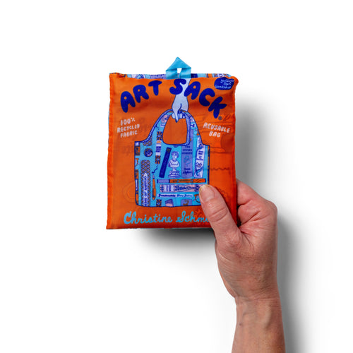 Person holding illustrated literary tote bag featuring banned books and female and queer authors by Yellow Owl Workshop