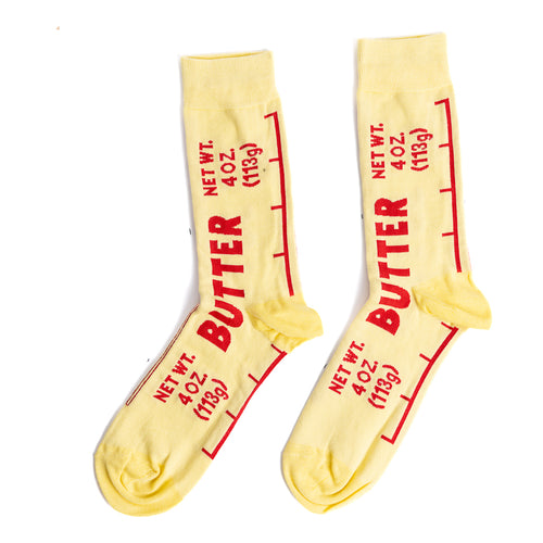 Yellow crew socks designed to look like a butter wrapper with bold red Butter label and Net Wt 4 oz text by Yellow Owl Workshop