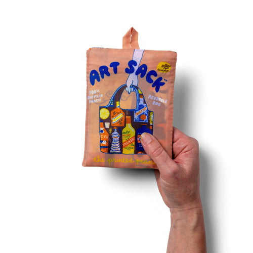 Person holding illustrated cocktail tote bag with vintage spirit bottle print by The Printed Peanut for Yellow Owl Workshop