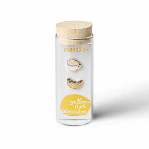 Coffee and croissant mismatched cloisonné stud earrings in glass vial packaging by Yellow Owl Workshop