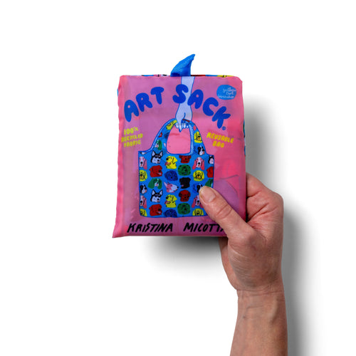 Person holding illustrated dog tote bag with colorful playful dog print by Kristina Micotti for Yellow Owl Workshop