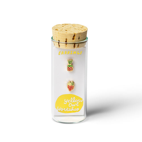 Yellow Owl Workshop mismatched strawberry candy stud earrings inspired by nostalgic strawberry hard candies from grandma's purse. Red and green gold-tone enamel earrings displayed in signature glass vial packaging with a cork stopper.