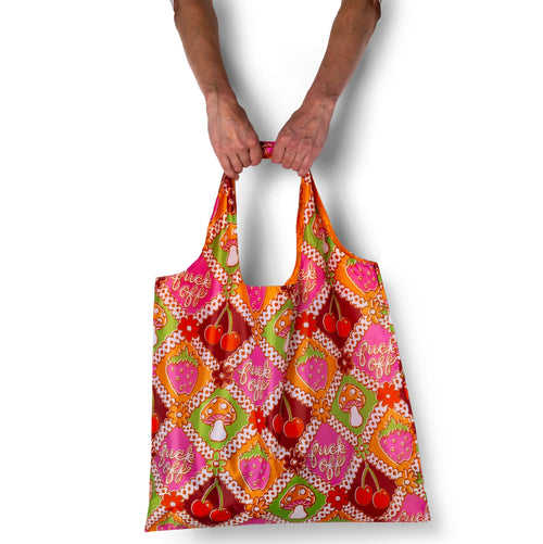 Person holding illustrated funny retro tote bag with vintage fruit and mushroom print by Yellow Owl Workshop