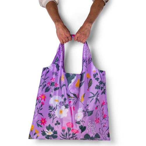 Person holding lavender illustrated botanical tote bag with whimsical floral print by Banquet Workshop for Yellow Owl Workshop