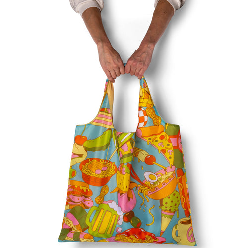 Colorful patterned tote bag held by a person on a white background