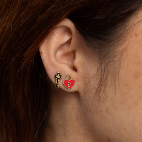 Heart lock and key mismatched cloisonné stud earrings worn on ear by Yellow Owl Workshop