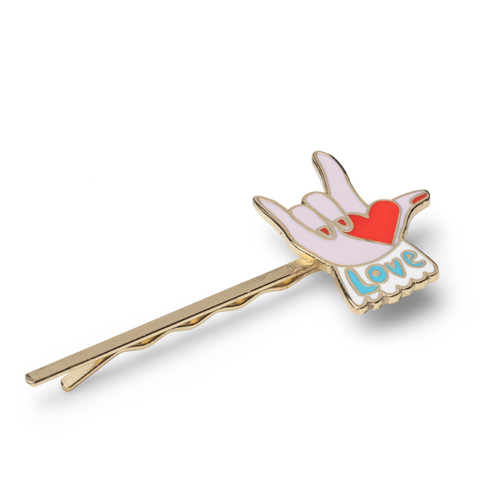 Gold cloisonné enamel love hair pin with lavender hand holding red heart and Love lettering by Yellow Owl Workshop