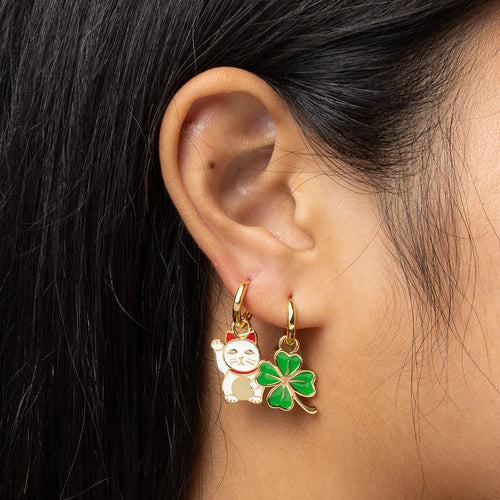 Lucky Cat and Clover gold hoop earrings worn on ear by Yellow Owl Workshop