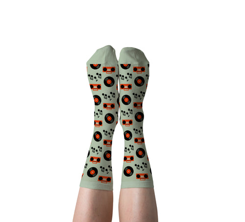 Light sage green Music crew socks with vinyl records and boomboxes worn on feet by Yellow Owl Workshop