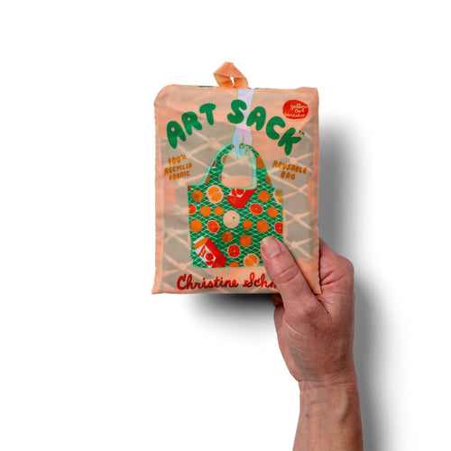 Person holding green illustrated citrus tote bag with orange fruit print by Yellow Owl Workshop