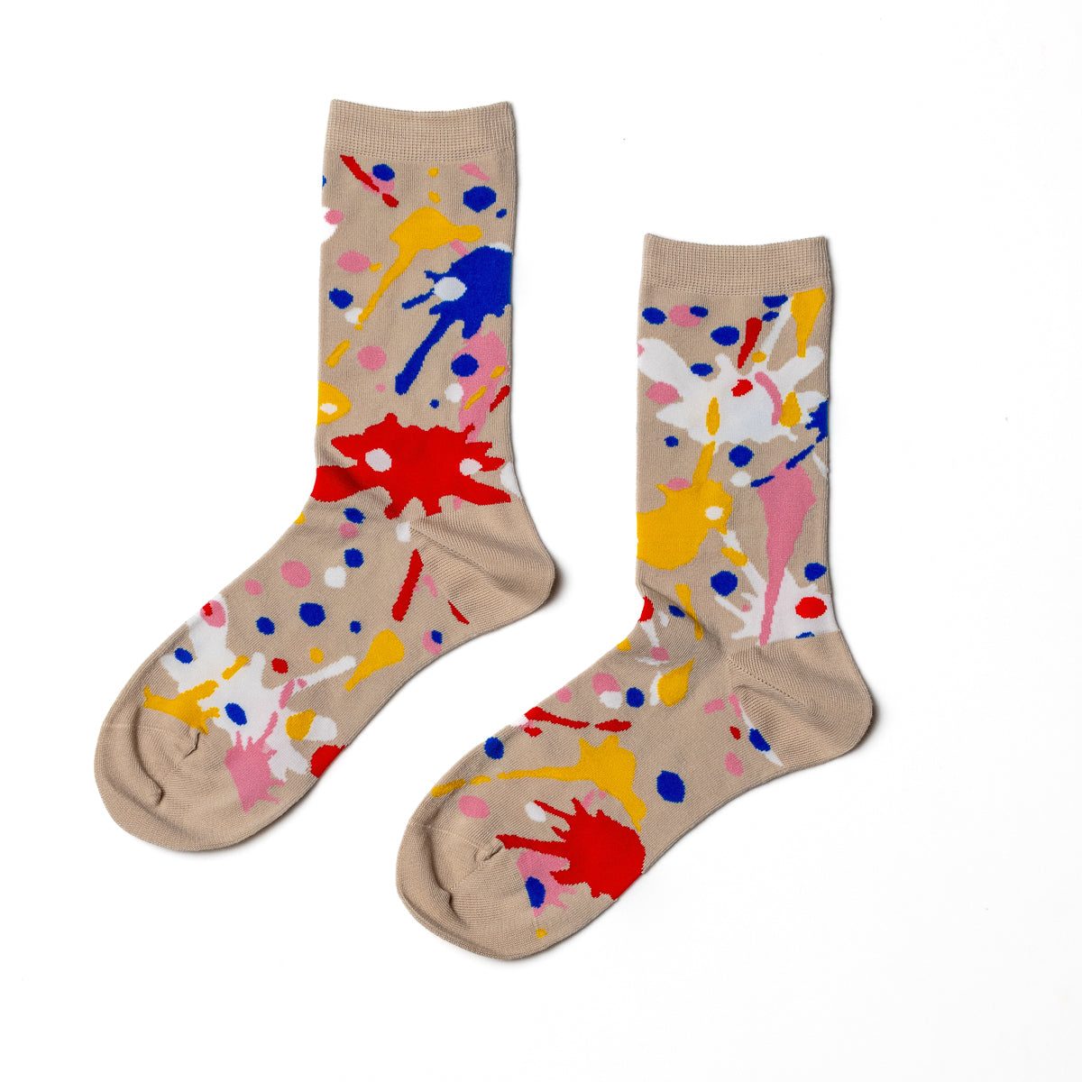 Tan crew socks featuring colorful paint splatter in red blue yellow pink and white by Yellow Owl Workshop