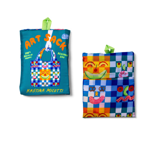 Picnic Art Sack® folded front and back showing colorful food illustration and red Art Sack® packaging by Kristina Micotti for Yellow Owl Workshop