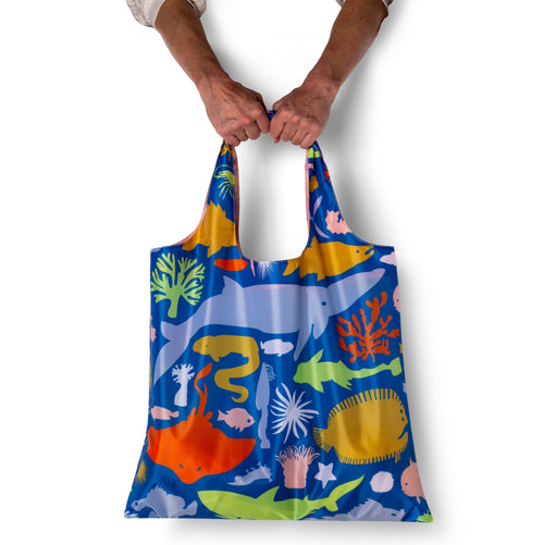 Person holding blue illustrated ocean tote bag with detailed sea animal print by Banquet Workshop for Yellow Owl Workshop