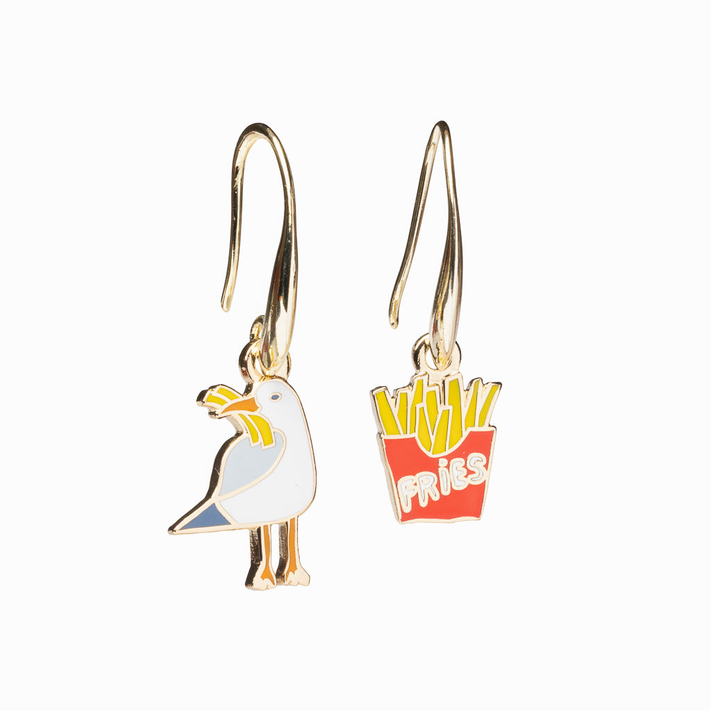 Mismatched enamel drop earrings featuring seagull and red carton of fries by Yellow Owl Workshop