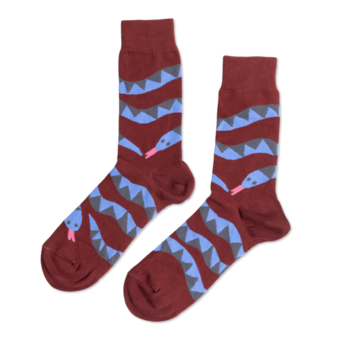 Burgundy crew socks featuring blue illustrated snake winding through bold grey zigzag stripe pattern by Yellow Owl Workshop