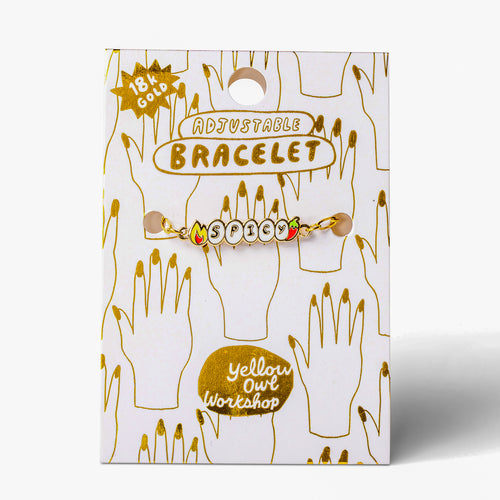 Enamel Spicy letter charm bracelet on gold foil packaging card by Yellow Owl Workshop