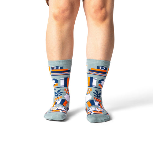 Person wearing patterned socks on a white background