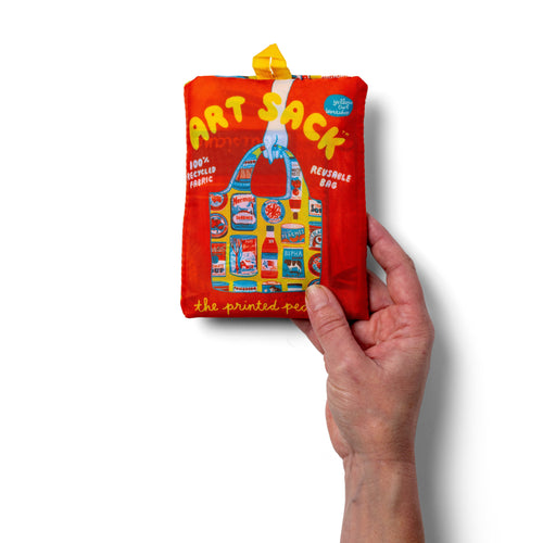 Person holding yellow illustrated reusable tote bag with vintage food can print by The Printed Peanut for Yellow Owl Workshop
