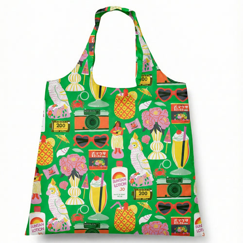 Illustrated reusable tote bag featuring colorful retro tropical vacation icons including pineapples cocktails film cameras and cockatoo by Naomi Wilkinson for Yellow Owl Workshop