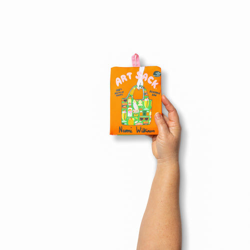Person holding illustrated tropical tote bag with colorful retro vacation print by Naomi Wilkinson for Yellow Owl Workshop
