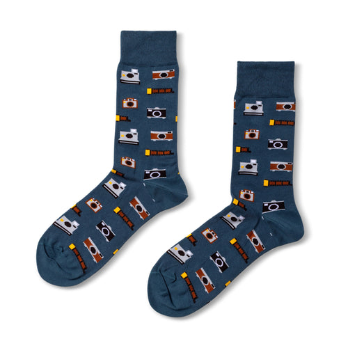 Blue crew socks featuring illustrated vintage cameras and film strips in brown black and white by Yellow Owl Workshop