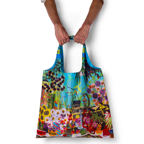 Person holding illustrated contemporary art tote bag with surreal colorful collage print by Paul Wackers for Yellow Owl Workshop