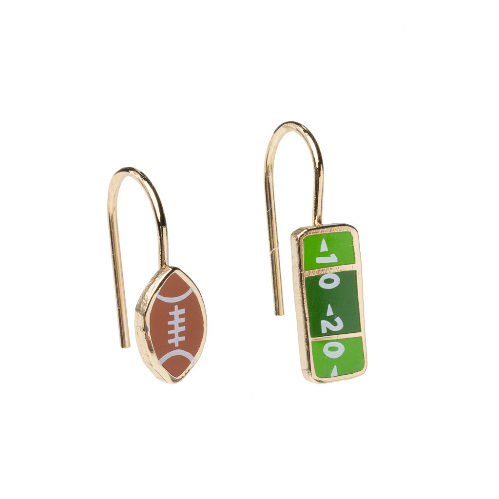 A pair of drop earrings, one shaped like a football with yard lines, the other shaped like a football with a different yard line design. 