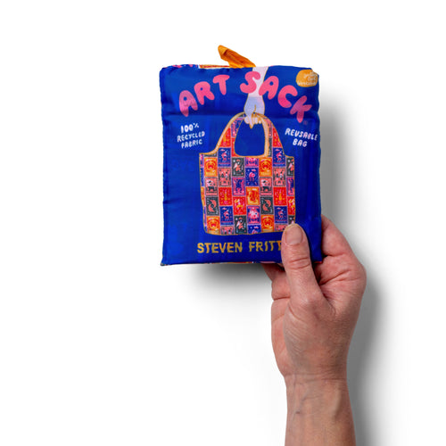 Person holding illustrated zodiac tote bag with colorful astrology symbols by Roisin O'Donnell for Yellow Owl Workshop
