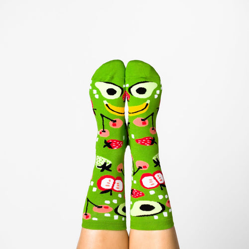 Bright green Fruits crew socks with colorful fruit print worn on feet by Yellow Owl Workshop