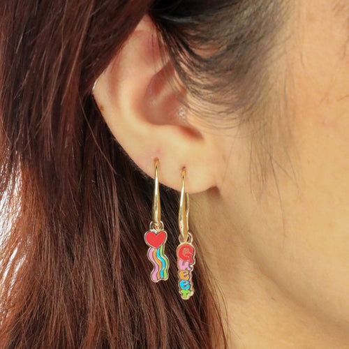 Queer Heart mismatched enamel drop earrings worn on ear by Yellow Owl Workshop