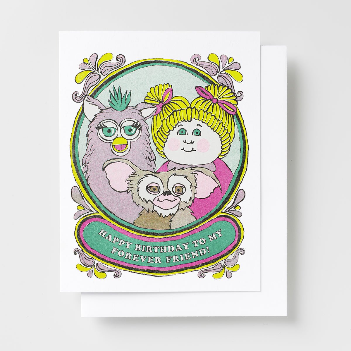 Risograph greeting card with an illustrated portrait of a Furby, Cabbage Patch doll, and Gremlin in a decorative oval frame, text reads Happy Birthday to My Forever Friend on a teal banner